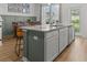 Kitchen island with granite countertops and gray-painted cabinets offers seating at 484 Trotters Ln, Moncks Corner, SC 29461