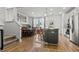 Open-concept kitchen with a gray island, white cabinets, and stainless steel appliances at 484 Trotters Ln, Moncks Corner, SC 29461