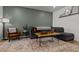 Comfortable living room with a gray sectional, modern decor, and wood-look flooring at 484 Trotters Ln, Moncks Corner, SC 29461