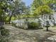 Backyard of house showcasing a large wooden deck with stairs surrounded by lush landscape at 4869 Slans Island Rd, Hollywood, SC 29449