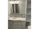 Bathroom featuring an elegant marble vanity, and a framed mirror at 4869 Slans Island Rd, Hollywood, SC 29449