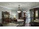 Inviting dining room featuring an antique table set under a vintage chandelier, blending classic charm with warm lighting at 4869 Slans Island Rd, Hollywood, SC 29449