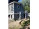Two story house with blue siding, white trim, and deck with steps and white railings leading to a second story entrance at 4869 Slans Island Rd, Hollywood, SC 29449