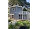 Two story house with blue siding, white trim, deck with steps and white railings and screened-in porch at 4869 Slans Island Rd, Hollywood, SC 29449