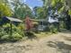 Charming home nestled amongst lush greenery, showcasing a long porch and tranquil setting at 4869 Slans Island Rd, Hollywood, SC 29449