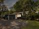 Back exterior of a home with outside lighting surrounded by mature landscaping at 4869 Slans Island Rd, Hollywood, SC 29449
