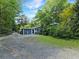 Back view of home featuring a spacious backyard and exterior door with a small covered porch at 4869 Slans Island Rd, Hollywood, SC 29449