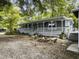 Inviting home featuring a cozy fire pit with stone benches and a spacious, covered front porch at 4869 Slans Island Rd, Hollywood, SC 29449