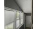 Bright hallway filled with natural light through multiple windows, leading to an exterior door for easy access at 4869 Slans Island Rd, Hollywood, SC 29449
