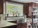 Close-up of kitchen sink, with stainless appliances, granite counters, and natural light at 4869 Slans Island Rd, Hollywood, SC 29449
