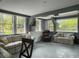 A partially furnished living room features large windows, seating, and gray trim at 4869 Slans Island Rd, Hollywood, SC 29449