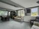 A partially furnished living room features large windows, seating, and gray trim at 4869 Slans Island Rd, Hollywood, SC 29449