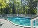 Backyard pool surrounded by a wooden deck and privacy fence offering a serene and secluded retreat at 4869 Slans Island Rd, Hollywood, SC 29449