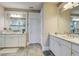 Bright bathroom with dual sinks, granite counters, white cabinets, tile floors, and glass shower at 5049 Song Sparrow Way, Summerville, SC 29483