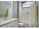 Modern bathroom featuring a granite countertop vanity and a shower-tub combo with white tile at 5049 Song Sparrow Way, Summerville, SC 29483