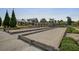 Well-maintained bocce ball court with manicured landscaping, sidewalks, and a view of the community's common buildings at 5049 Song Sparrow Way, Summerville, SC 29483