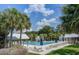 Relaxing community pool surrounded by palm trees, lounge chairs, and covered cabanas for a resort-style experience at 5049 Song Sparrow Way, Summerville, SC 29483
