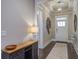 Inviting foyer with stylish light fixture, elegant decor, and a view of the front door and hardwood floors at 5049 Song Sparrow Way, Summerville, SC 29483