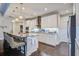 Open kitchen with granite countertops, stainless steel appliances, pendant lighting, and dark hardwood floors at 5049 Song Sparrow Way, Summerville, SC 29483