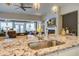Open concept kitchen featuring a stainless steel sink, granite countertops, and an adjacent living area at 5049 Song Sparrow Way, Summerville, SC 29483