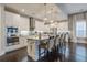 Bright kitchen features stainless steel appliances, granite counters, three pendant lights, and hardwood floors at 5049 Song Sparrow Way, Summerville, SC 29483