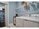 Functional laundry room featuring a modern washer and dryer set with wire rack shelving at 5049 Song Sparrow Way, Summerville, SC 29483