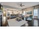 Spacious living room with hardwood floors, a cozy fireplace, and an open view to the kitchen and dining area at 5049 Song Sparrow Way, Summerville, SC 29483