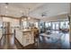 Open-concept kitchen and living area featuring stainless steel appliances, granite countertops, and hardwood floors at 5049 Song Sparrow Way, Summerville, SC 29483