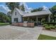 Outdoor kitchen and entertainment area featuring brick accents, stainless steel grills, and ample space for gatherings at 5049 Song Sparrow Way, Summerville, SC 29483