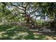 Community playground featuring a tree house, benches, and a secure fenced area for children to play safely at 5049 Song Sparrow Way, Summerville, SC 29483