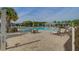 Beautiful community pool area with ample seating, umbrellas, and lush landscaping, perfect for relaxation at 5049 Song Sparrow Way, Summerville, SC 29483