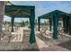 Relaxing poolside cabanas, comfortable seating, and lush landscaping around the community pool area at 5049 Song Sparrow Way, Summerville, SC 29483