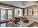 Cozy sitting room with comfortable armchairs, hardwood floors, and natural light streaming through large windows at 5049 Song Sparrow Way, Summerville, SC 29483