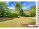 Well-maintained backyard featuring lush greenery, mulch, and a privacy hedge at 505 Eastern Isle Ave, Summerville, SC 29486