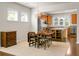 A well-lit dining room features wood floors, a modern light fixture, and opens to the kitchen at 505 Eastern Isle Ave, Summerville, SC 29486