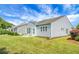 Back exterior view of home with a green lawn, and a patio with an outdoor seating set at 505 Eastern Isle Ave, Summerville, SC 29486