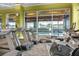 Bright community gym featuring treadmills, exercise bikes, and an indoor pool visible through large windows at 505 Eastern Isle Ave, Summerville, SC 29486