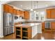 A well-appointed kitchen with wood cabinets, a kitchen island, stainless steel appliances, and granite countertops at 505 Eastern Isle Ave, Summerville, SC 29486