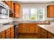 Wood cabinets, granite counters, and stainless appliances make this kitchen desirable at 505 Eastern Isle Ave, Summerville, SC 29486