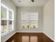 A sun-lit room featuring gleaming wood floors, neutral paint, and windows with mini-blinds at 505 Eastern Isle Ave, Summerville, SC 29486