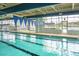 Indoor pool with blue pennant flags, marked lanes, and ample natural light from large windows at 505 Eastern Isle Ave, Summerville, SC 29486