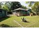 Green backyard with covered porch at 5452 E Lakeland Dr, North Charleston, SC 29406