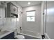 Bathroom with tiled walls, updated fixtures, and natural light at 5452 E Lakeland Dr, North Charleston, SC 29406