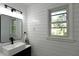 Stylish bathroom featuring a black framed mirror, white vessel sink, and modern fixtures at 5452 E Lakeland Dr, North Charleston, SC 29406
