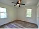 Bright bedroom with hardwood floors, a ceiling fan, and natural light at 5452 E Lakeland Dr, North Charleston, SC 29406
