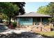 Attractive home showcasing a side porch, brick accents, and professional landscaping at 5452 E Lakeland Dr, North Charleston, SC 29406