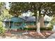 Charming home with a brick and siding exterior and a mature tree in the front yard at 5452 E Lakeland Dr, North Charleston, SC 29406