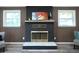 Close-up of the fireplace with intricate brass details and modern white marble base adding luxury and charm at 5452 E Lakeland Dr, North Charleston, SC 29406