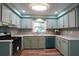 Updated kitchen features stainless steel appliances, designer backsplash, and elegant light fixtures, enhancing functionality and style at 5452 E Lakeland Dr, North Charleston, SC 29406
