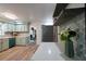 Well-lit kitchen showcasing sage green cabinetry, stylish backsplash and modern countertops at 5452 E Lakeland Dr, North Charleston, SC 29406